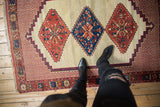 View of the triple geometric medallions and intricate stepped border of a Persian Afshar rug.