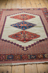 Angled perspective showing the geometric progression of medallions on an antique Persian Afshar rug.