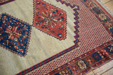The intricate, multi-banded border and stepped medallion of a late 19th-century Persian Afshar rug.