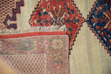 Corner view of an antique Afshar rug showing the hand-knotted foundation and side cord selvage.