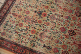 Fine weave on Zuli Sultan rug's ivory field with varied red floral blossoms and even wear.