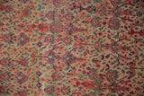 Fine weave of antique Zuli Sultan rug, ivory, red floral motifs, with visible even wear.
