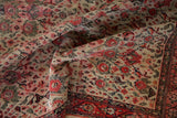 Antique Zuli Sultan rug with finely woven ivory field, blush red blossoms, and traditional border.