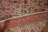 Fine weave detail of antique Zuli Sultan rug: fringe, red geometric border, ivory floral field.