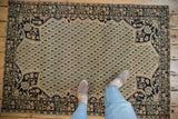 Antique Farahan Sarouk corner with fine floral spandrels and ivory, navy, blush boteh motifs.