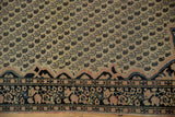 Corner detail of antique Farahan Sarouk rug, blush spandrel with tendrils, navy floral border.
