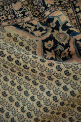 Antique Persian Farahan Sarouk rug, germinating boteh motifs and floral spandrel in ivory, navy, blush.
