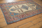 Vintage Bakshaish rug detail with blush pink, sky blue borders, and zigzag motif.