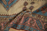 Distressed Bakshaish rug border featuring blush, sky blue serrated leaves and field blossoms.