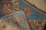 Hand knotted vintage Bakshaish rug back, fringed edge, and distressed blue, blush floral pile.
