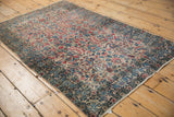 Vintage Kerman rug corner, showing millefleur field, splayed floral and patinated navy border.