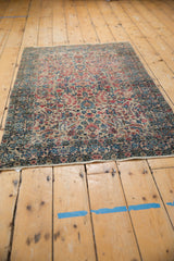 Patina-softened vintage Kerman rug with millefleur, palmette design in ivory, red, and blue.