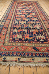 Fine antique Armenian Karabagh runner detail: geometric blossoms and playful animals in navy, coral, ivory.