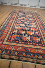 Intact fringe and vibrant geometric border on a fine antique Karabagh rug end.