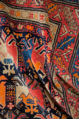 Close view of antique Karabagh runner, hand-knotted pile with navy, red, orange animal motifs.