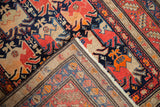 Antique Karabagh runner's hand-knotted reverse weave and vibrant geometric pile at a folded corner.
