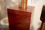 Solid oak wood base with visible grain and twisted copper coils of the Edison lamp.