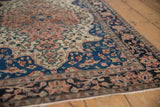 Exquisite pinwheel floral petals and scalloped contour on an antique Persian Farahan Sarouk rug.