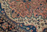 Antique Farahan Sarouk rug detail: blush, indigo, ivory floral vinery and scalloped contour.