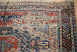 Hand-woven antique Soumac carpet detail with geometric patterns and exposed foundation.