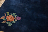 Pale tangerine and violet floral bouquet on a cobalt blue Nichols Art Deco rug.