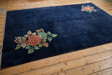 Navy blue field with original intact side cord selvage of a vintage Art Deco carpet.