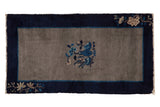 Vintage Chinese Peking rug, beige field, indigo border, vase and floral motifs.
