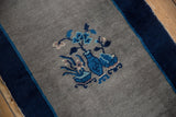 Pictorial vase and flower motif on the vintage Peking rug in cobalt, indigo, and silver.