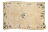 Antique Peking rug, circa 1910, cream field with central floral design and blue corner branches, 5' x 7'6