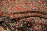 Vintage Malayer rug with brick red boteh pattern field and distinct geometric border.