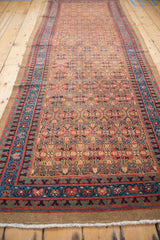 Elongated vintage Persian Serab runner, repeating henna plant lattice in camel, sapphire, and brick red.