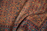 Sapphire blue geometric border and henna plant motif on a vintage Serab rug.