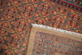 Vintage Serab rug detail: sapphire blue, brick red henna plant design, fringe, and woven back.