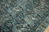Close-up of distressed Meshed rug with dusty blue arts and crafts motifs, exposed foundation.