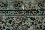 Distressed vintage Meshed carpet pile with dusty blue, indigo, and blush botanicals, showing foundation.