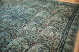 Distressed vintage Meshed rug with dusty blue, blush botehs, and dark indigo border.