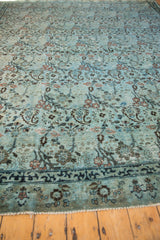 Distressed Meshed carpet, dusty powder blue field with visible threadbare regions near dark indigo border.