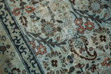 Faded dusty blue Meshed carpet, floral patterns, indigo outlines, and exposed foundation.