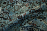 Distressed texture of vintage Meshed carpet, dusty blue, dark indigo, blush botanical motifs.