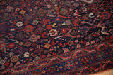Detailed geometric motifs of plants, birds, and animals in navy and ruby red.