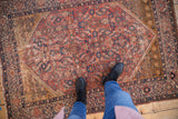 Fuchsine red antique Malayer rug underfoot, featuring Herati motif, saffron spandrels, visible wear.