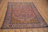 Unusual deep saffron corner spandrel with geometric motifs on the antique Malayer rug.