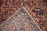 Worn antique Malayer rug pile with fuchsine red Herati pattern, exposing foundation and fringe.