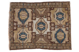 Distressed Hamadan square rug: cobalt blue medallions on a geometric brown and beige field.