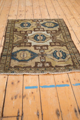 Geometric distressed Hamadan rug's coffee brown border and cobalt blue trellis.