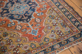 Detailed texture of a vintage Heriz rug's low pile, revealing the weave and floral border.