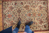 Antique Fereghan rug's ivory ground, large lotus flower cross-sections, and expressive vinery.