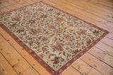 Corner of antique Fereghan rug, showing ivory field, lotus-vinery design, and terracotta boteh border.
