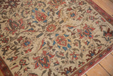Antique Fereghan rug detail showing ivory ground with terracotta lotus flowers, sky blue accents, and a classic red boteh border.