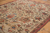 Unusual ivory ground on an antique Fereghan rug with lotus, vine, and boteh border.
